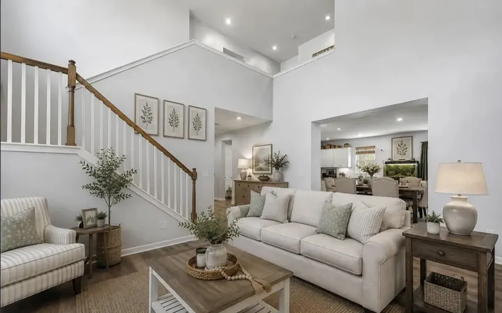 Living room with staircase and view to kitchen
