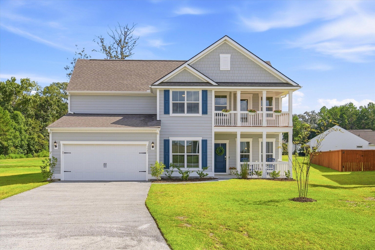 5085 Lady Bird Alley, a gray house with double front porches in Sea Island Preserve